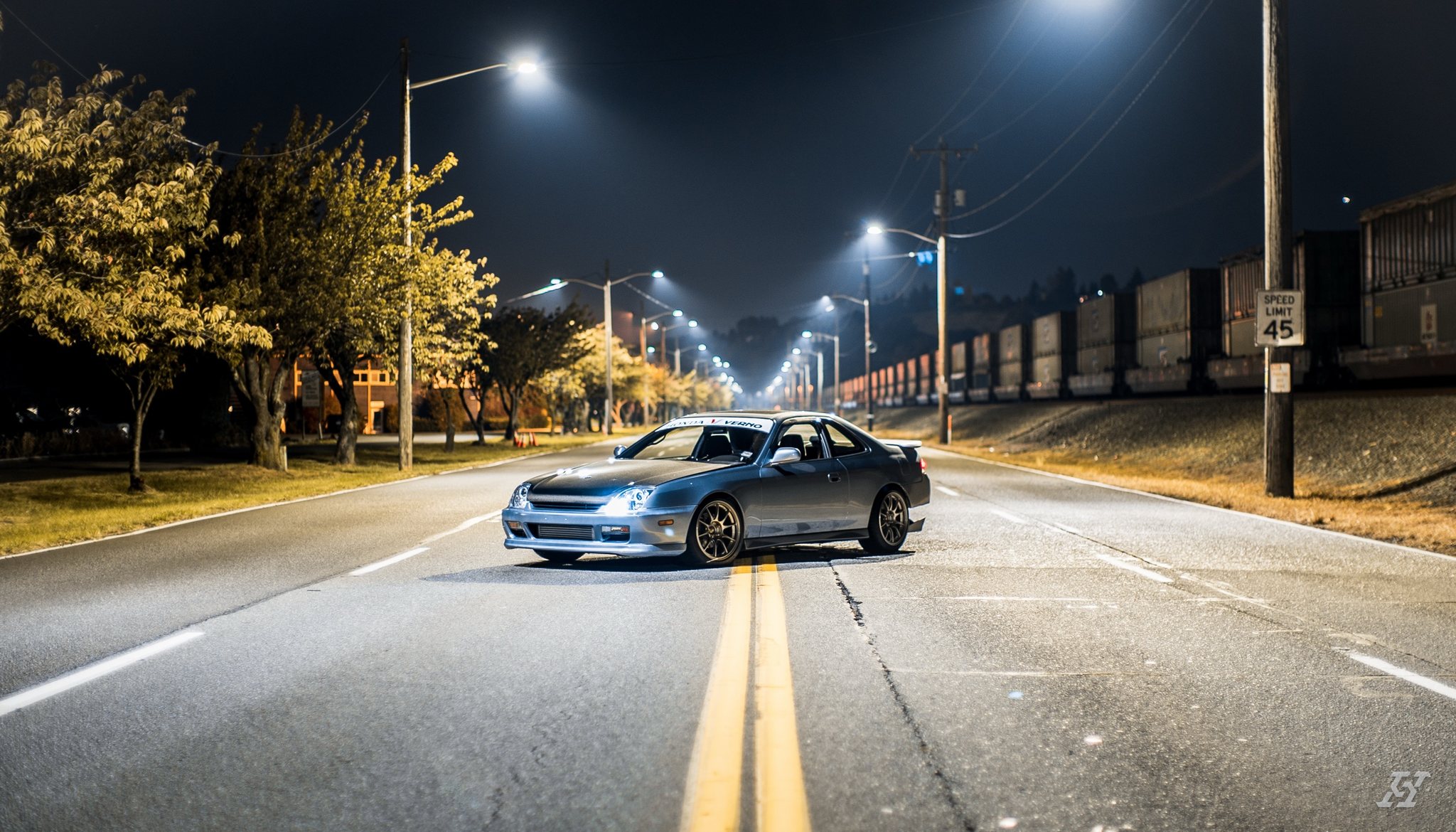 Crystal Blue Metallic Honda Prelude parked on an empty street at night under streetlights, after an exterior detail by High Standard Auto Salon